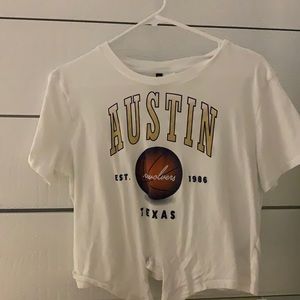 white t-shirt with basketball team on front